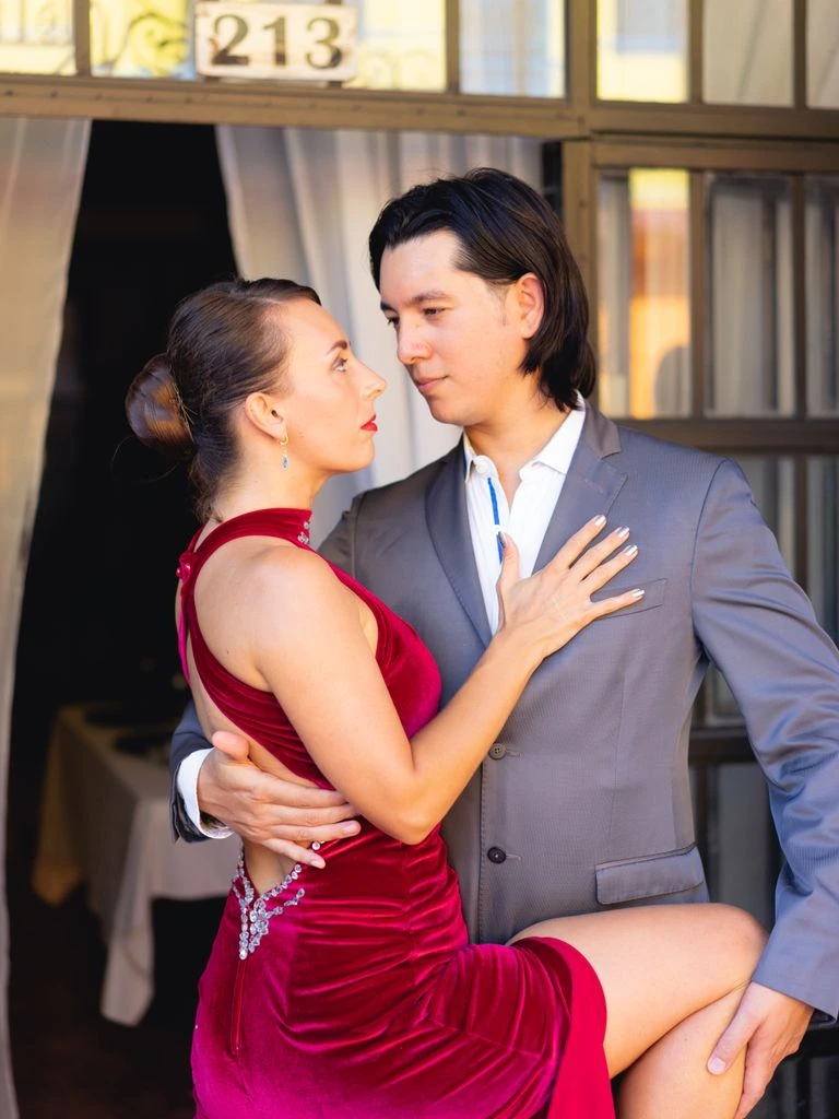 A first-time student learning the embrace in a beginner class
